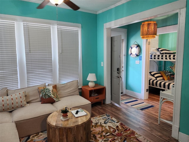 2219 33rd St E, Galveston, TX 77550 - living room featuring crown molding, baseboards, ceiling fan, and wood finished floors