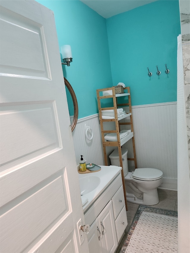 bathroom with tile patterned floors, vanity, and toilet