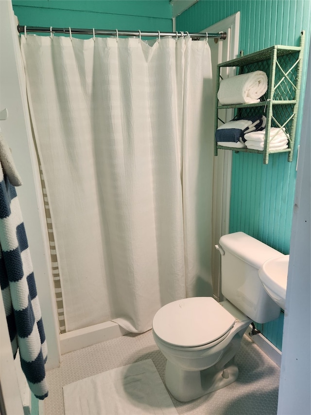 bathroom with walk in shower and toilet