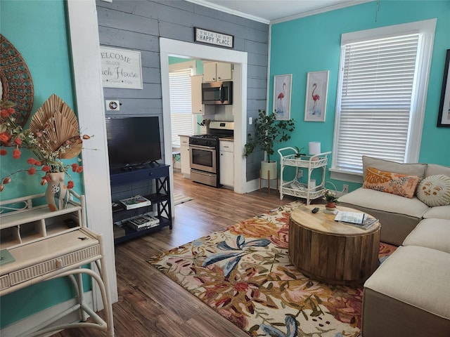 2219 33rd St E, Galveston, TX 77550 - living area with wood walls, ornamental molding, wood finished floors, and plenty of natural light