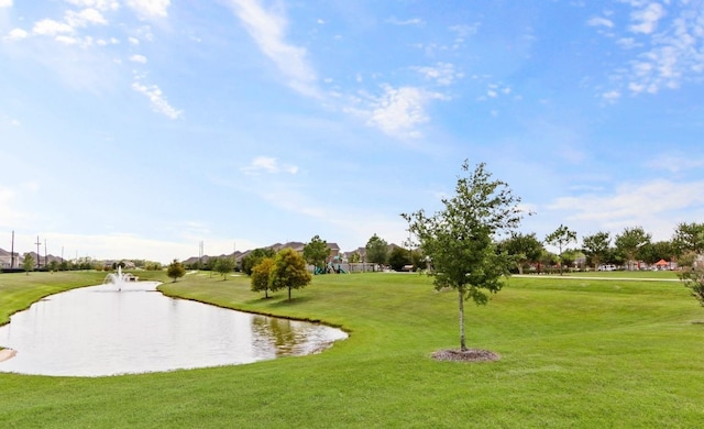 view of property's community featuring a water view and a yard