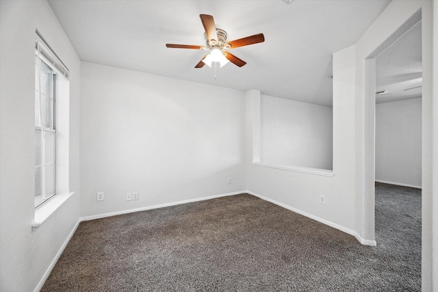 carpeted spare room with ceiling fan and a healthy amount of sunlight