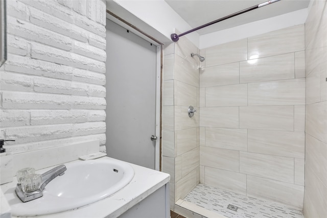 bathroom featuring vanity and tiled shower