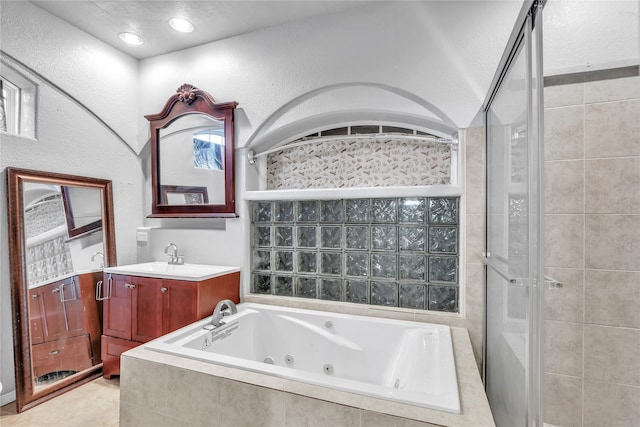 bathroom featuring vanity, a textured ceiling, independent shower and bath, and tile patterned flooring