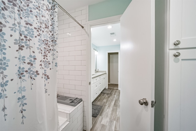 bathroom with vanity, a shower with curtain, and wood-type flooring