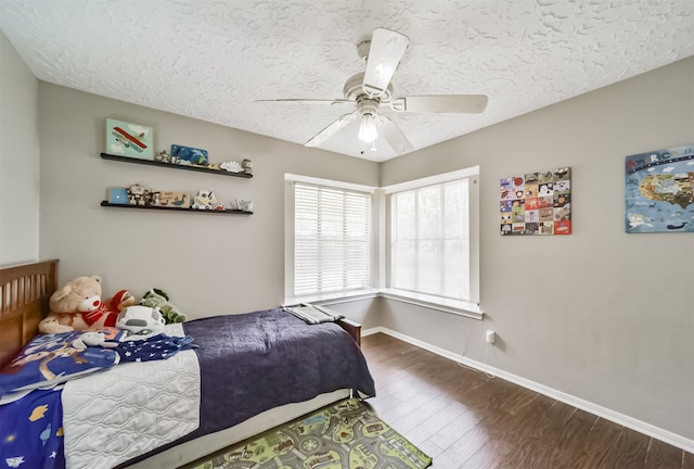 bedroom featuring a textured ceiling, ceiling fan, and hardwood / wood-style flooring