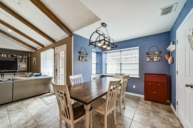 dining room with a notable chandelier, light tile patterned floors, french doors, and lofted ceiling with beams