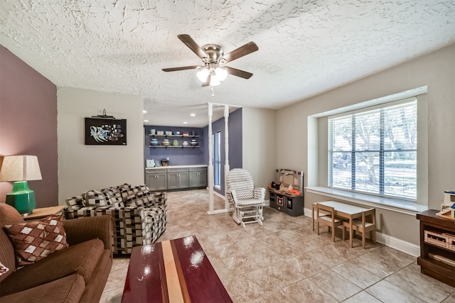 tiled living room with a textured ceiling and ceiling fan