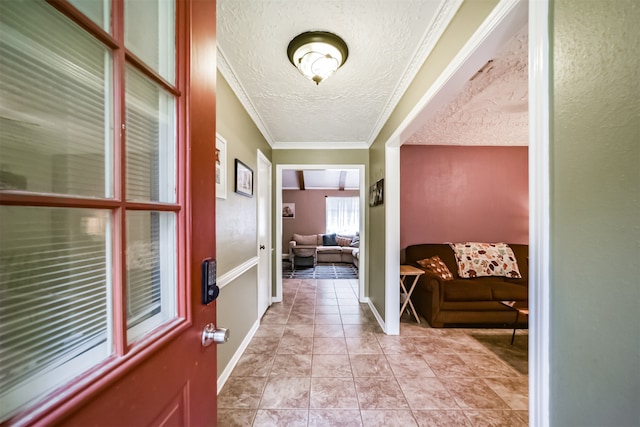 interior space with a textured ceiling, ornamental molding, and light tile patterned flooring