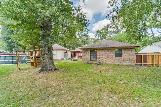 rear view of house featuring a yard