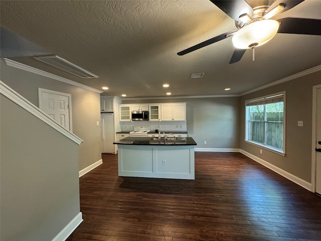 kitchen featuring white cabinets, dark hardwood / wood-style flooring, white appliances, and backsplash