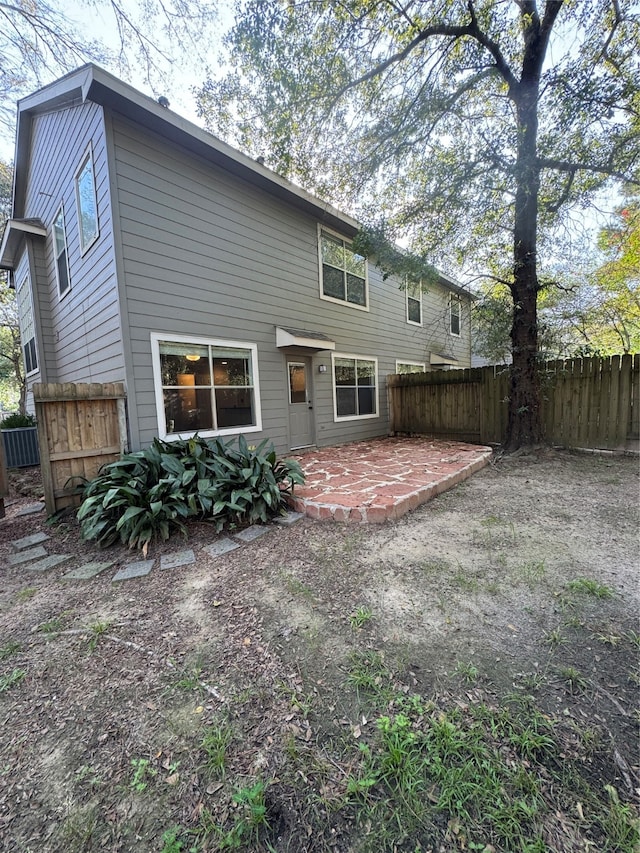 back of property with a patio