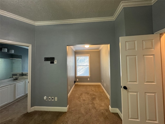 hall featuring carpet, a textured ceiling, and crown molding