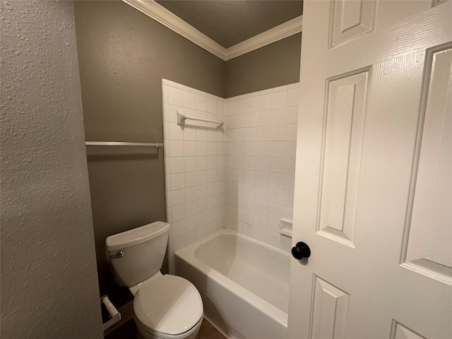 bathroom featuring toilet, ornamental molding, and tiled shower / bath