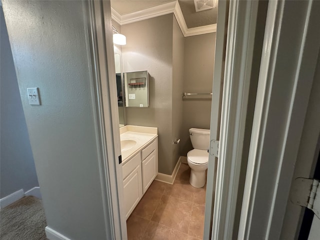 bathroom with tile patterned flooring, vanity, toilet, and crown molding