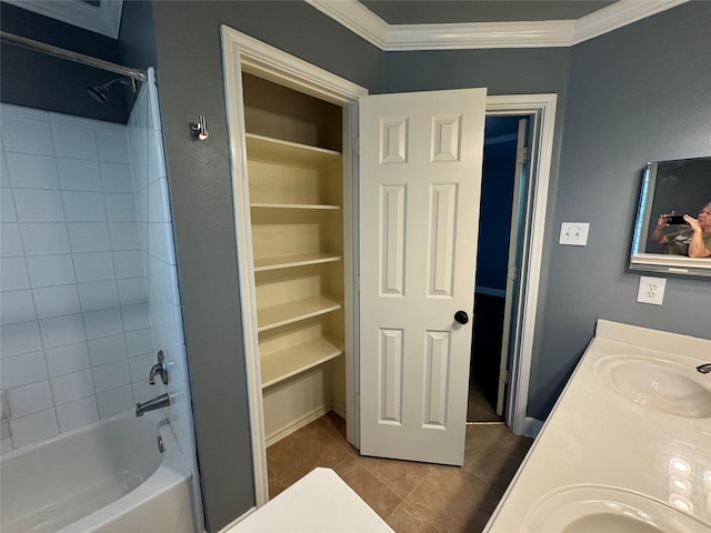 bathroom featuring vanity, tiled shower / bath combo, tile patterned floors, and crown molding