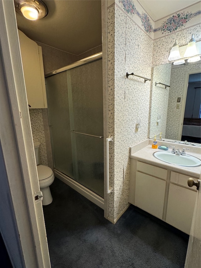 bathroom featuring walk in shower, vanity, and toilet