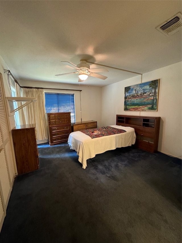 bedroom featuring ceiling fan and dark carpet