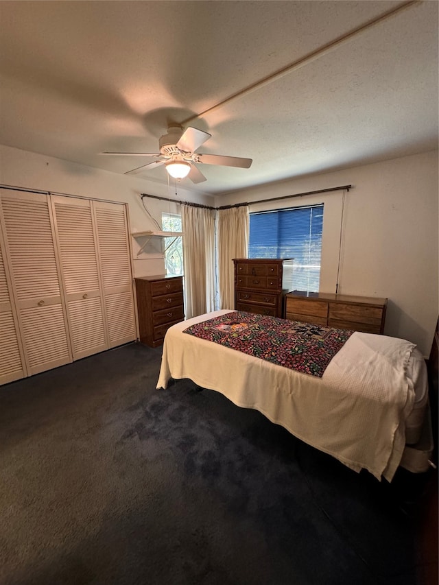 bedroom with dark carpet and ceiling fan