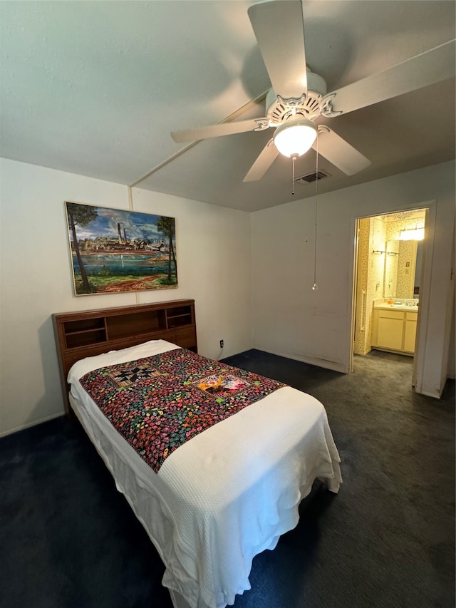 carpeted bedroom with ceiling fan and ensuite bathroom