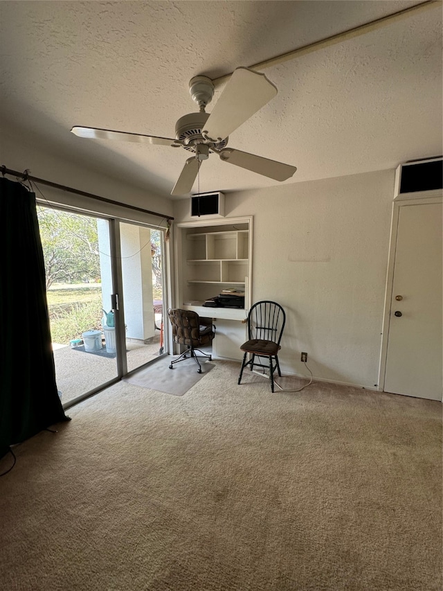 unfurnished room with a textured ceiling, carpet, and ceiling fan