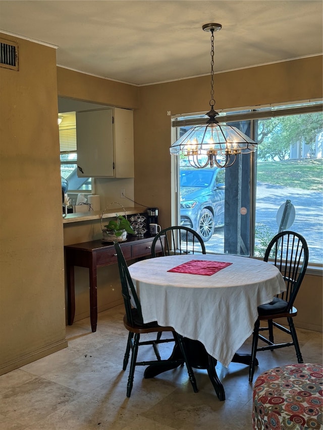 dining area with an inviting chandelier