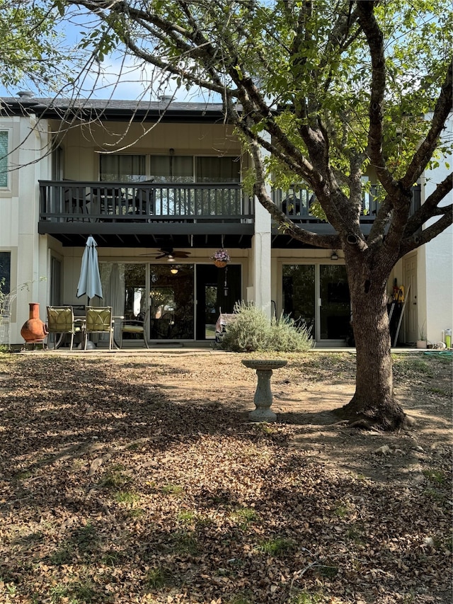 back of house featuring a balcony