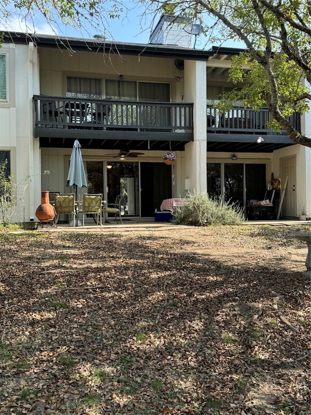 back of house featuring a balcony and a patio area