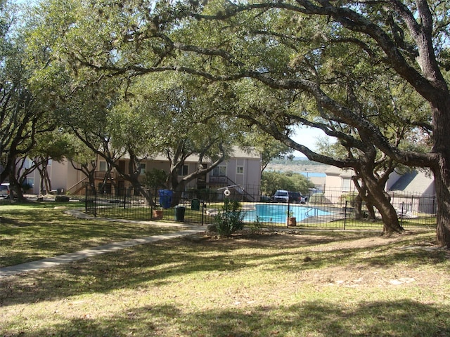 view of yard with a fenced in pool