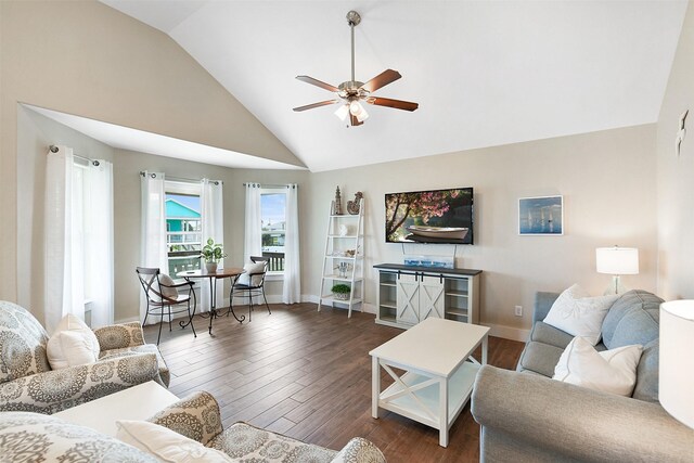 living room featuring dark wood-type flooring, high vaulted ceiling, and ceiling fan