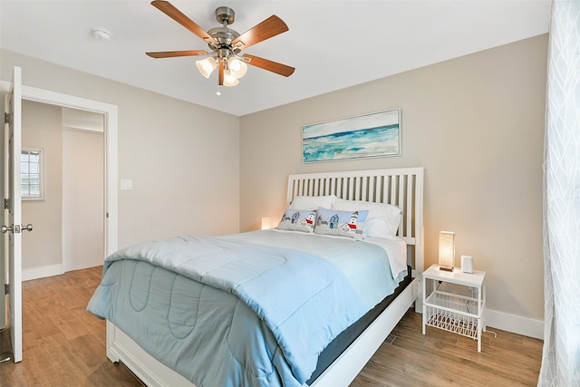 bedroom with ceiling fan and wood-type flooring