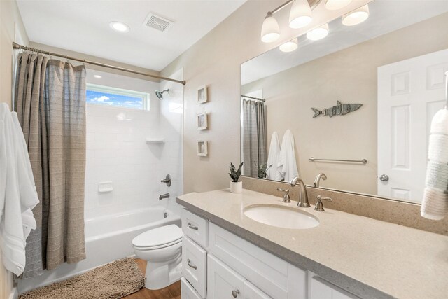 full bathroom with shower / bathtub combination with curtain, toilet, hardwood / wood-style flooring, and vanity