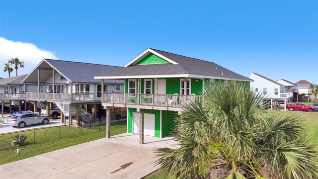 view of front of home featuring a garage, a porch, and a front yard