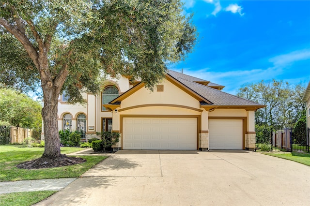 view of front of property with a garage and a front yard