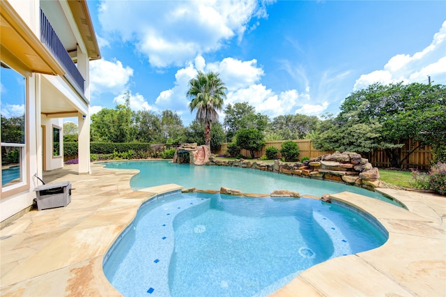 view of pool featuring a patio and an in ground hot tub