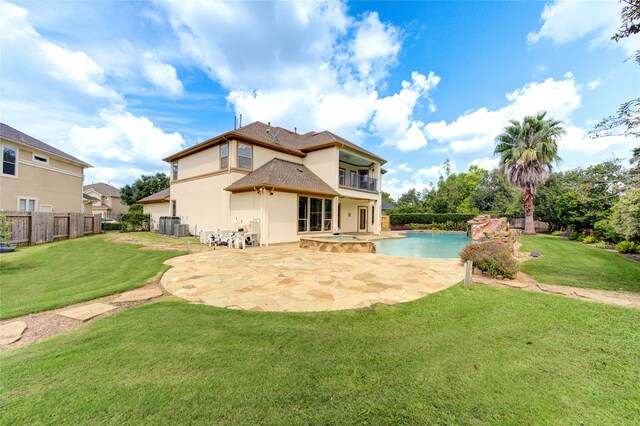 back of house featuring a balcony, a yard, a patio area, and central AC unit