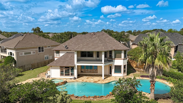 back of house with a balcony and a patio