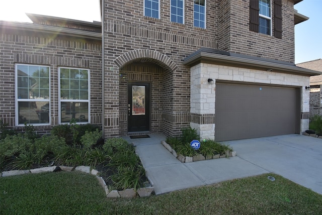 doorway to property with a garage