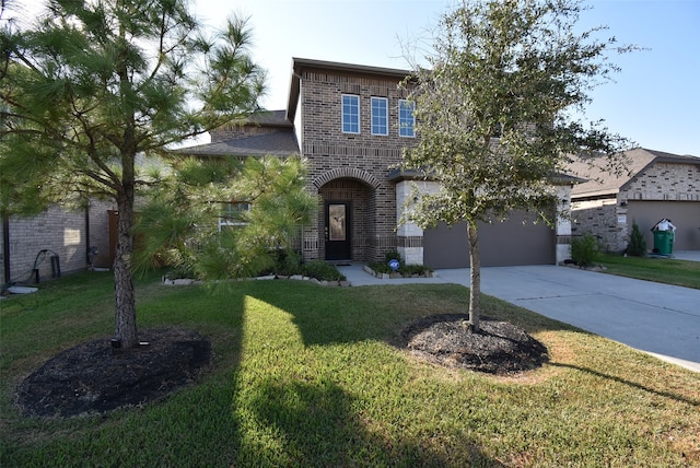 view of front of home with a front lawn and a garage