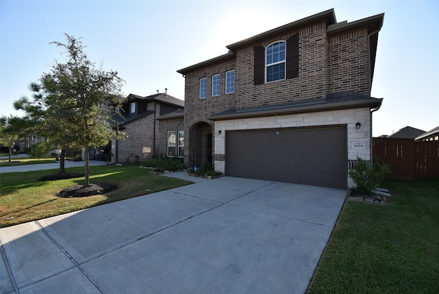 view of front of home featuring a front yard and a garage