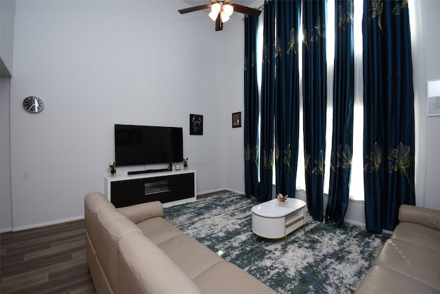 living room with dark hardwood / wood-style floors and ceiling fan