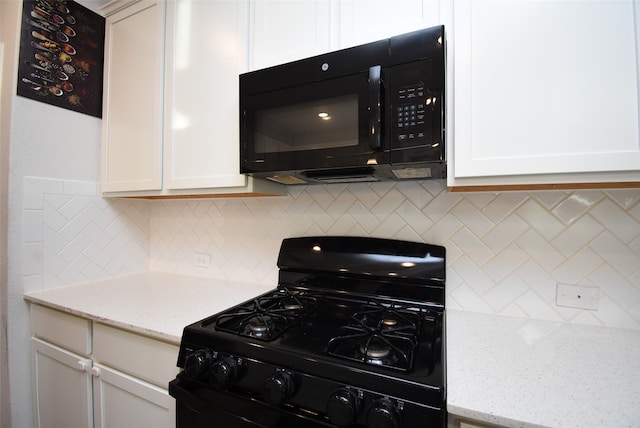 kitchen featuring white cabinetry, light stone countertops, tasteful backsplash, and black appliances