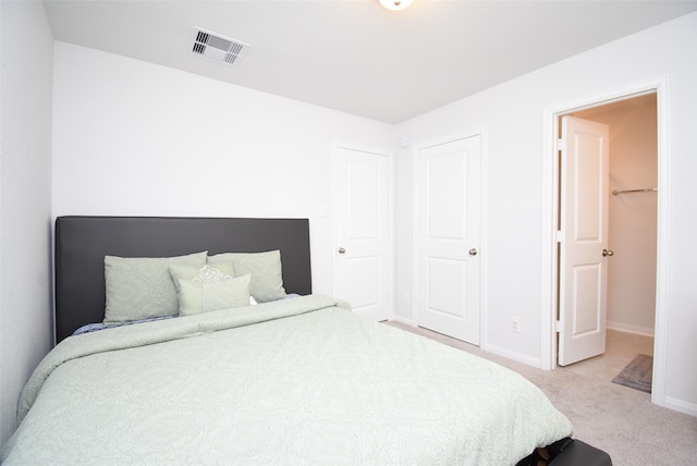 bedroom with light colored carpet