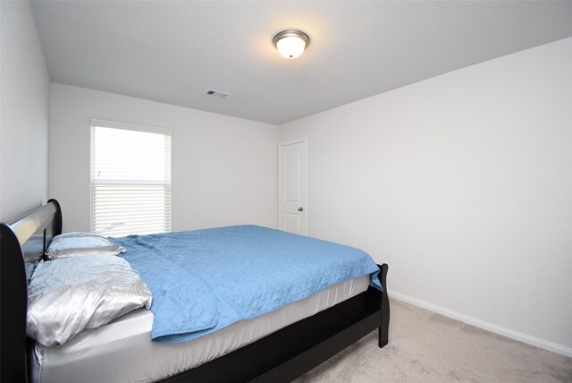 bedroom featuring light carpet