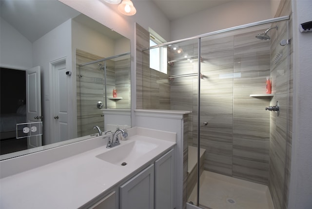 bathroom featuring vanity and a shower with shower door