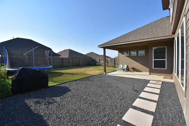 view of yard featuring a patio area and a trampoline