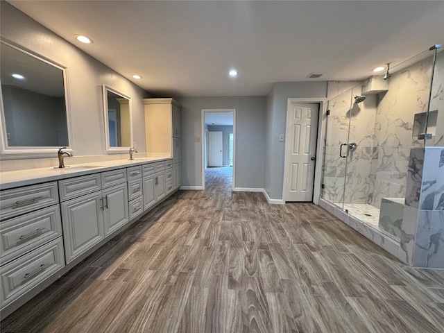 bathroom featuring vanity, hardwood / wood-style flooring, and an enclosed shower