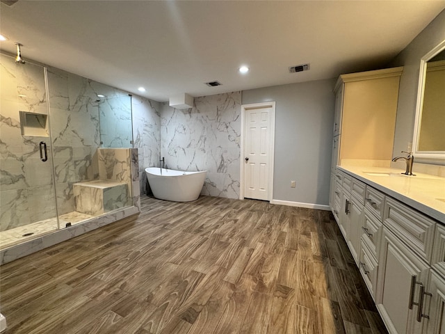 bathroom featuring vanity, hardwood / wood-style flooring, and shower with separate bathtub