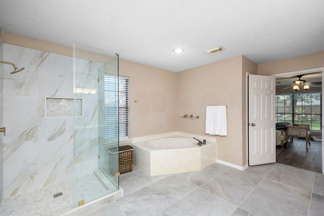 bathroom featuring shower with separate bathtub, a textured ceiling, and ceiling fan