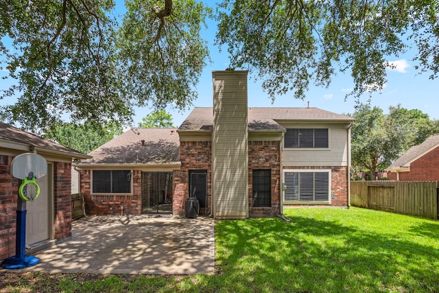 back of house featuring a yard and a patio